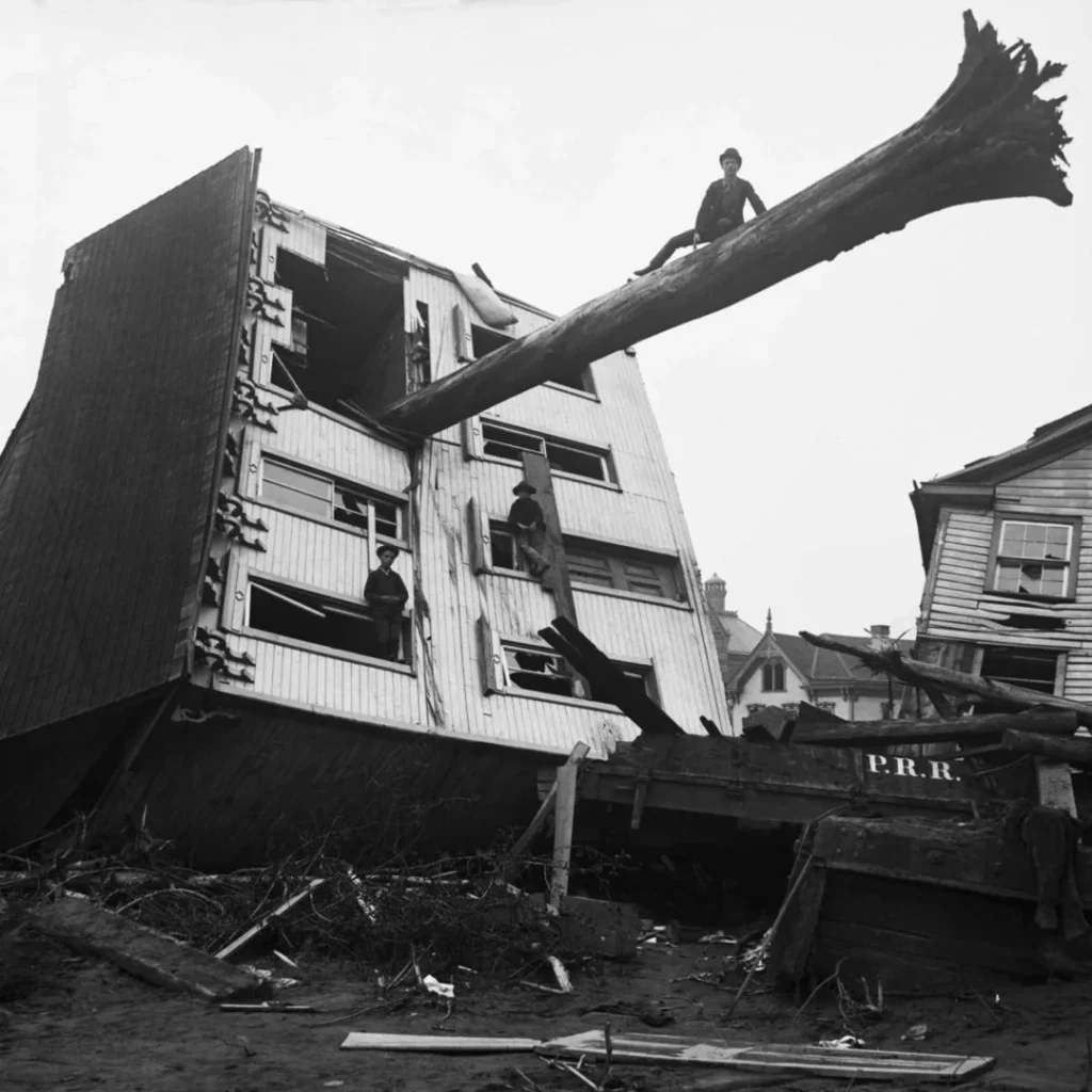 A house ripped from its foundation by the Johnstown flood, with a tree trunk sticking out of a window. 1889