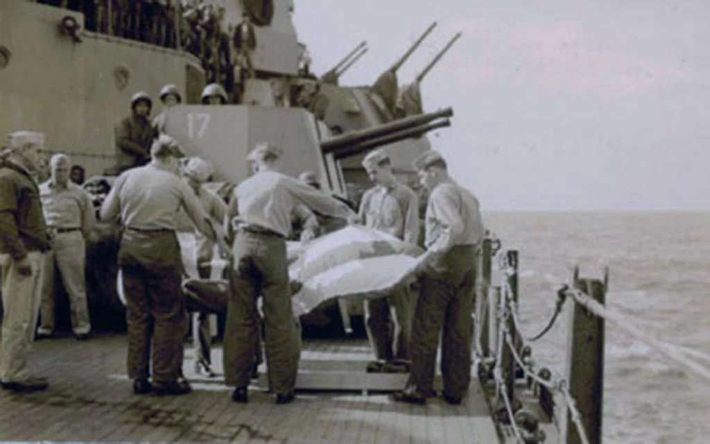 Burial at sea of Setsuo Ishino, the kamikaze pilot who struck the port side of the USS Missouri on April 11, 1945. After his body was retrieved from the wreckage of the plane, on orders from Captain William Callaghan, sailors buried him with full military honors. April 1945
