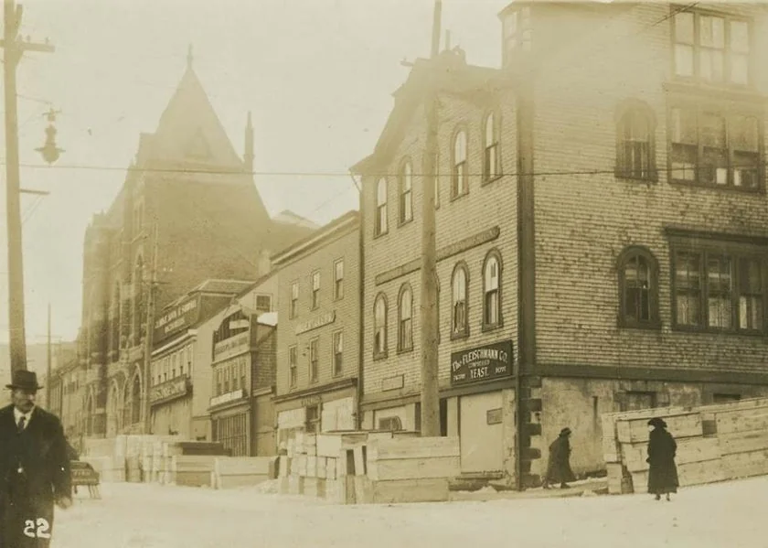 Coffins stacked outside Snow & Co. in the aftermath of the Halifax Explosion. December, 1917.