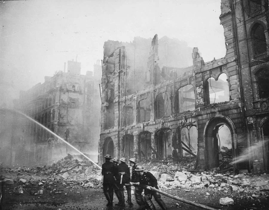Firefighters put out a blaze caused by a round of German bombings in London, 1941.