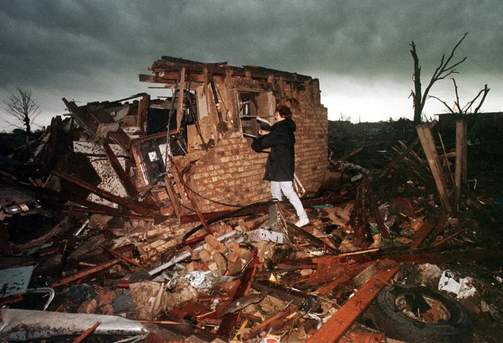 Peggy Lipscomb salvages belongings from what is left of her home following a series of deadly tornados that ravaged Oklahoma and parts of Kansas on 3 May 1999. During this week-long event, 154 tornadoes touched down, killing 50 people (Oklahoma City, Oklahoma 1999)