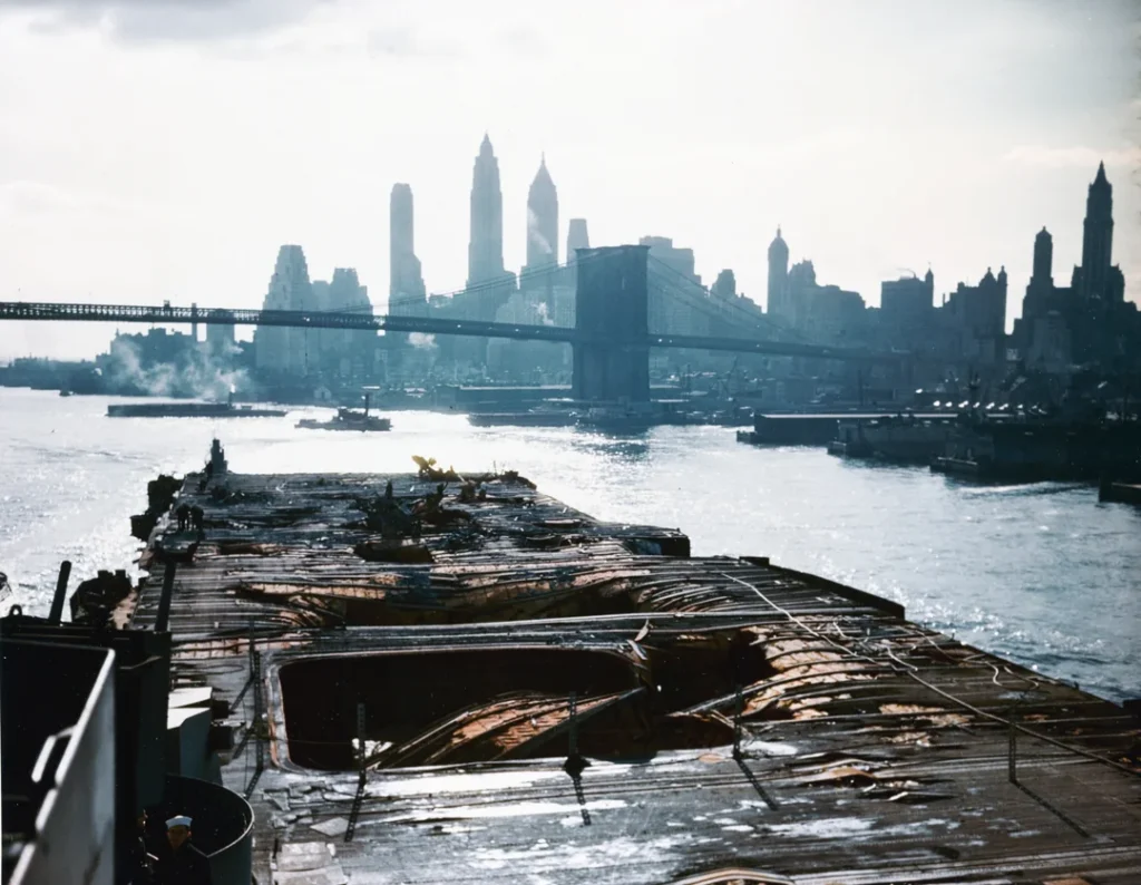 View of Manhattan from the bombed out deck of the USS Franklin, April 28, 1945. A little over a month prior, she had been attacked by Japanese aircraft, starting a blaze the killed over 700 men and nearly sank the ship, yet made it to NYC for repair under her own power.