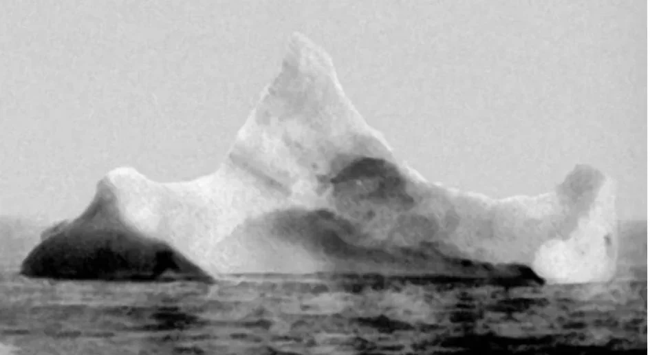 This was a photo taken in 1912 of an iceberg found with black and red paint in the Atlantic ocean. It is believed this was the iceberg that hit the Titanic.