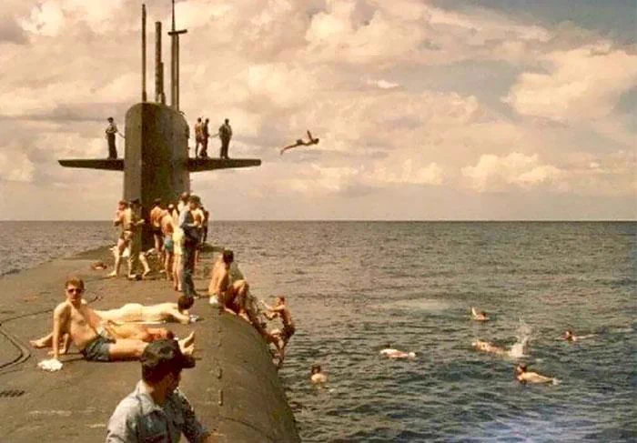 U.S. Navy sailors take part in a &ldquo;swim call&rdquo; in the Pacific Ocean, 1983.
