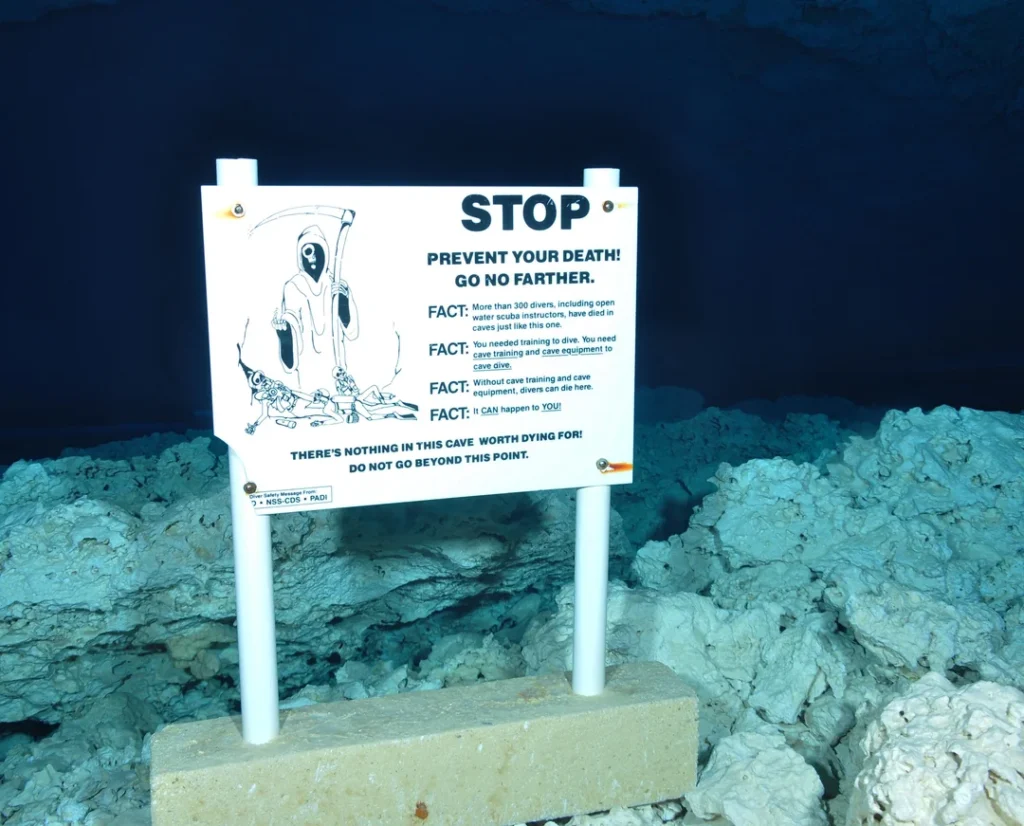 Terrifying warning sign in underwater cave.