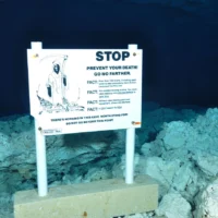Terrifying warning sign in underwater cave.