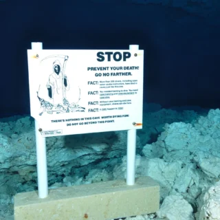 Terrifying warning sign in underwater cave.