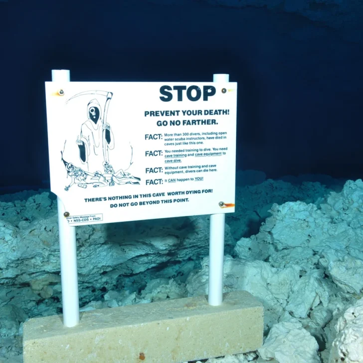 Terrifying warning sign in underwater cave.